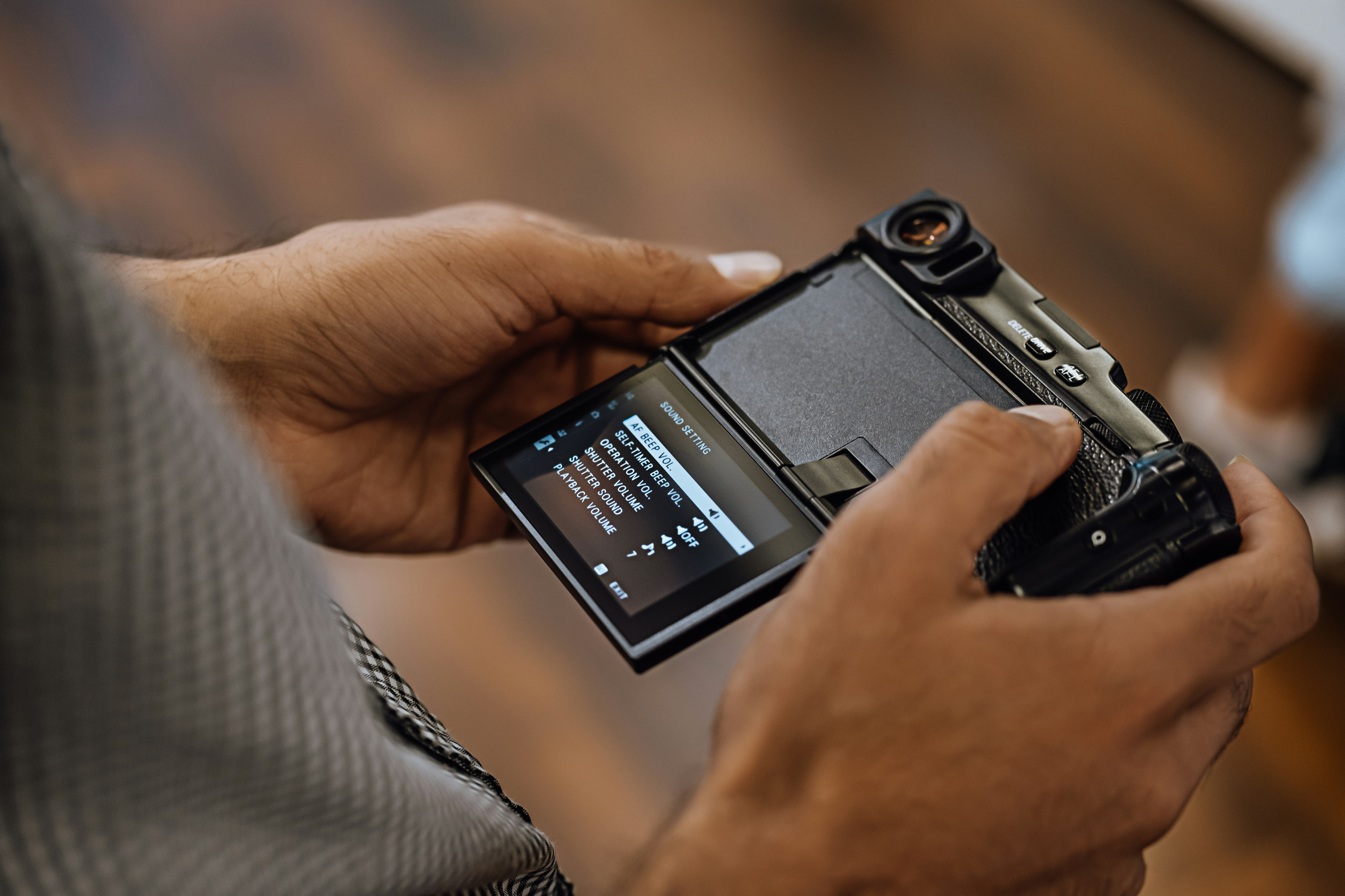 person holding black and silver digital camera